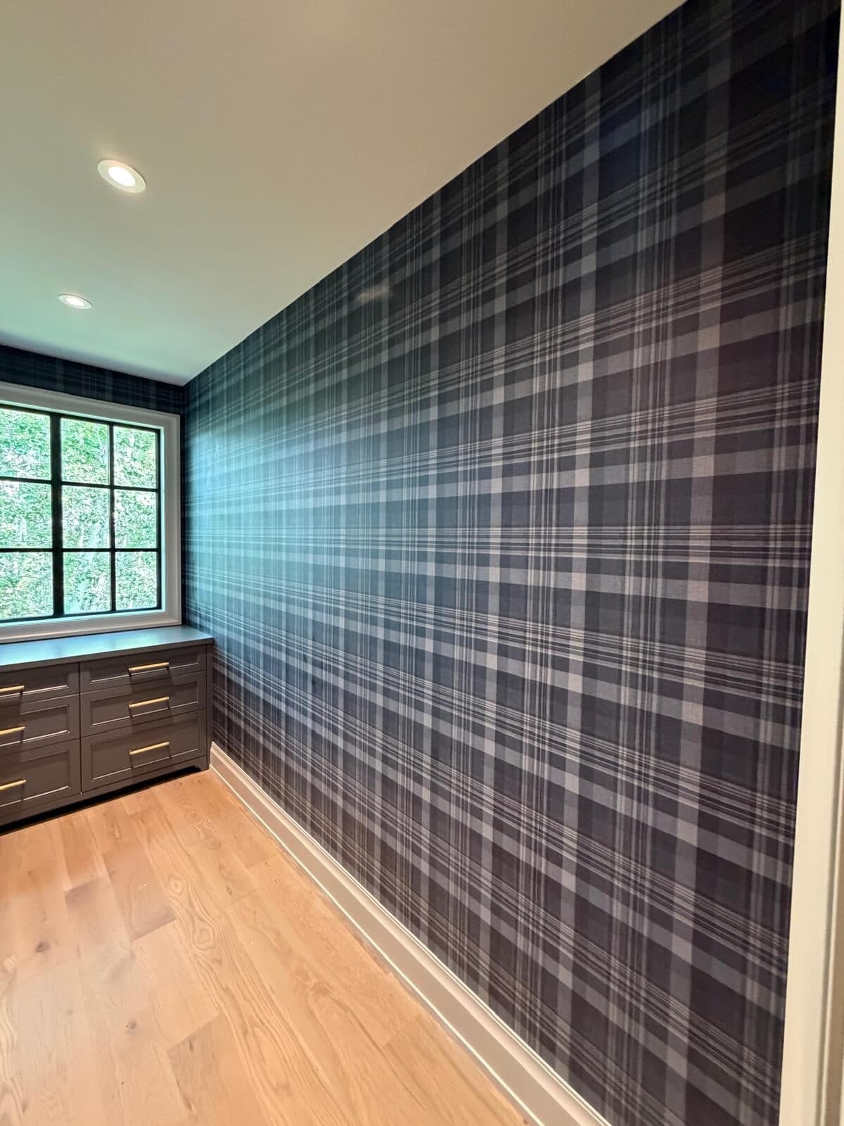 Navy and charcoal tartan plaid wallpaper on a walk-in closet feature wall in Elbow Valley