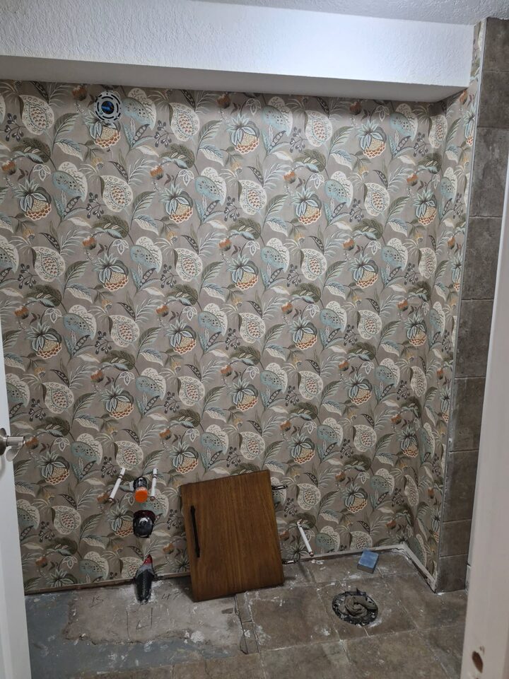 Botanical WallPops NuWallpaper installed on a Chinook Park Calgary bathroom vanity wall during renovation