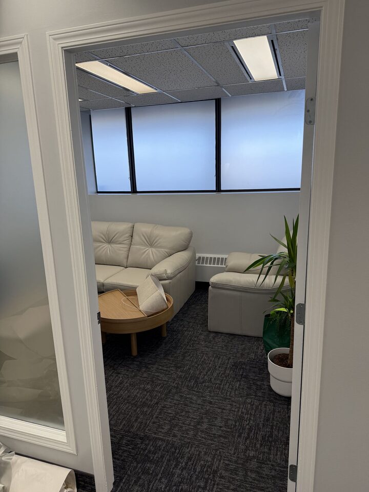 View through an office suite doorway to the frosted-film window wall in the lounge beyond, Centre 89 on Macleod Trail, Haysboro, SW Calgary