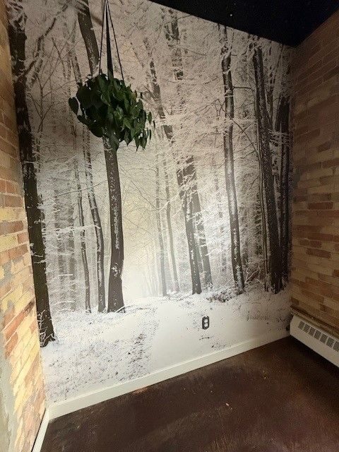 Snowy-forest wallpaper mural on a Lewis Lofts wall in Calgary's Beltline before removal