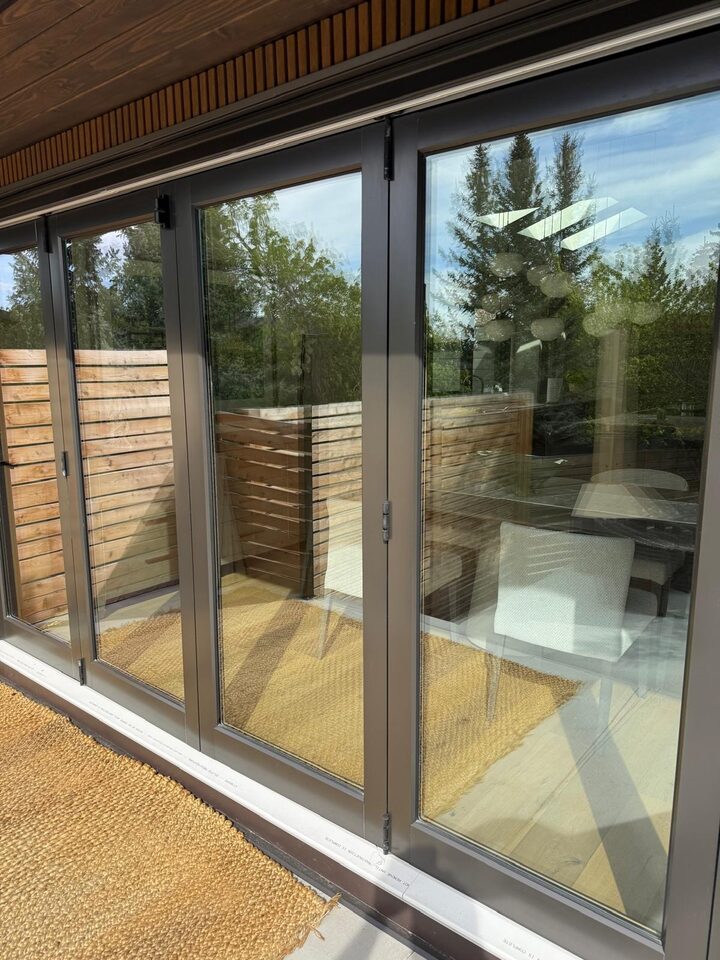 Before photo of clear patio door glass with a view straight into the interior, prior to solar window film in Britannia SW Calgary