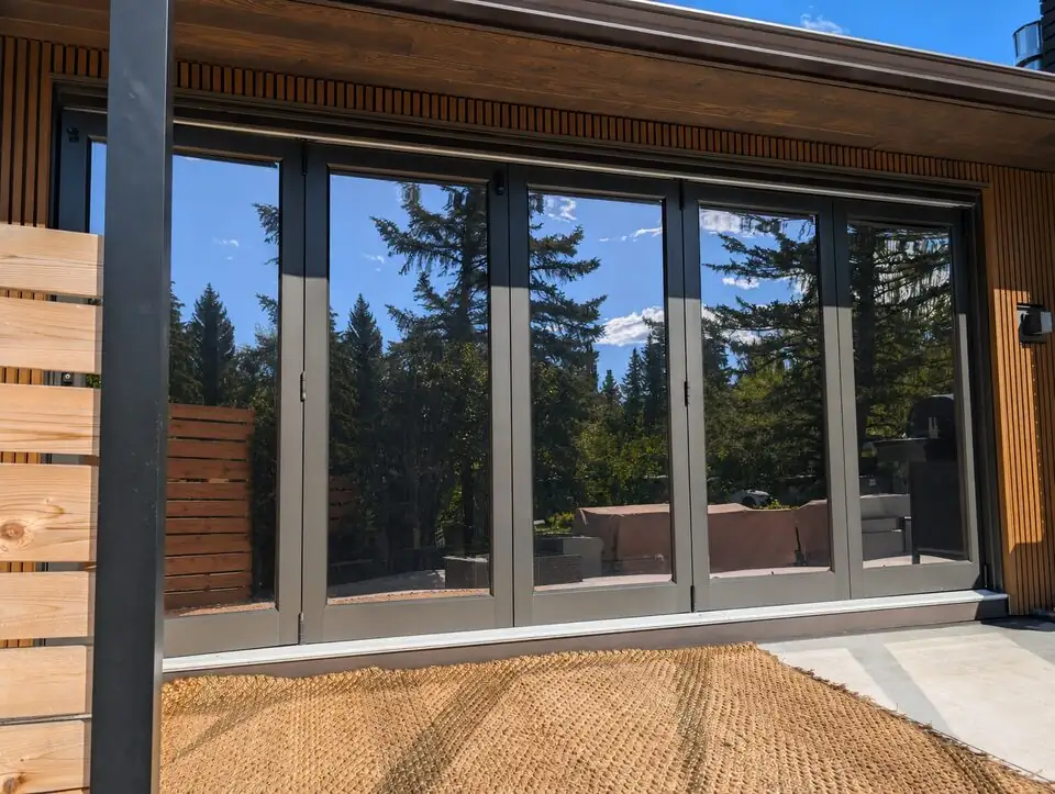 Reflective solar window film installed on folding patio doors in Britannia SW Calgary