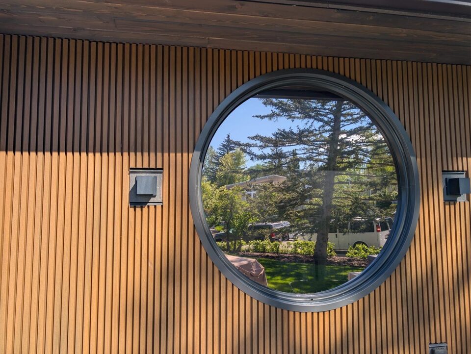 After photo of reflective solar window film on the round feature window in Britannia SW Calgary