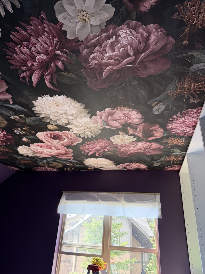 Dark floral mural wallpaper with blush peonies in a plum Canmore dressing room