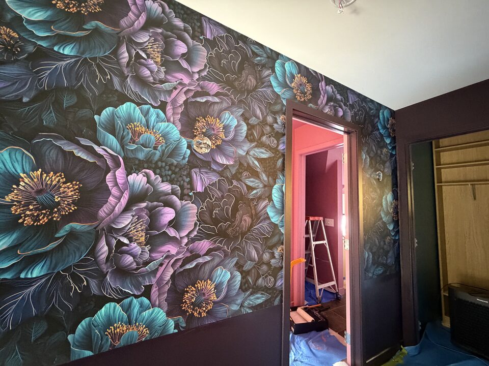 Teal and violet peony mural wallpaper with gold linework around a Canmore bedroom doorway