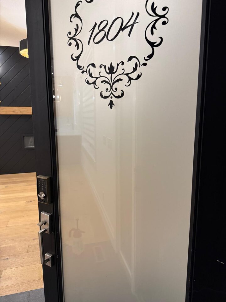 Close detail of Metamark Silver Etch frosted privacy window film on front entry door glass in Capitol Hill NW Calgary