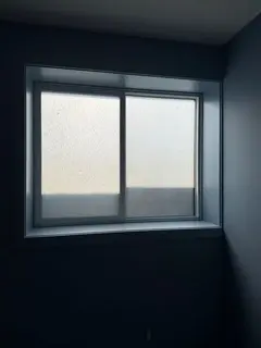 Frosted privacy window film on a Charleswood NW Calgary new build. Construction-soiled glass scraped clean, then frosted film for daylight w