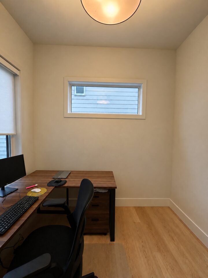 Crestmont, Calgary home office before the mural, a plain cream wall around a horizontal window above the desk