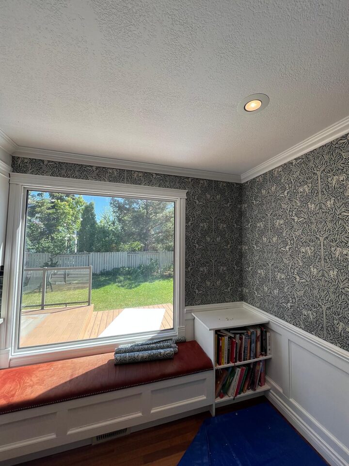 Full window corner view after black and white botanical wallpaper installation in a Deer Run SE Calgary dining room