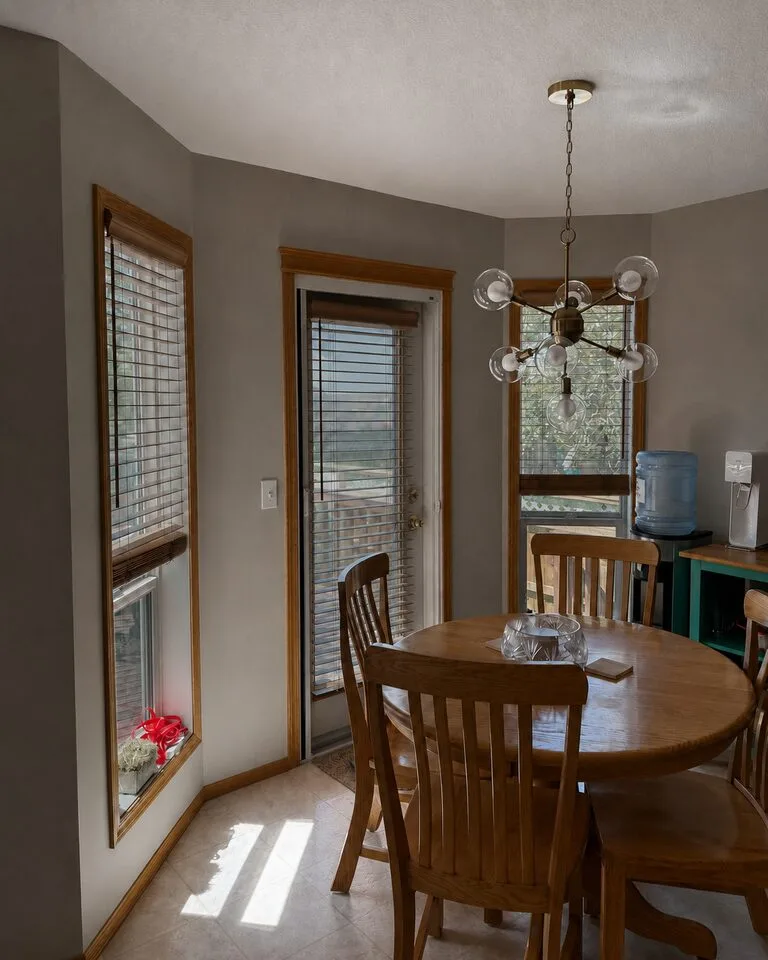 Dining area windows with new clear solar control film after replacement in Douglasdale SE Calgary