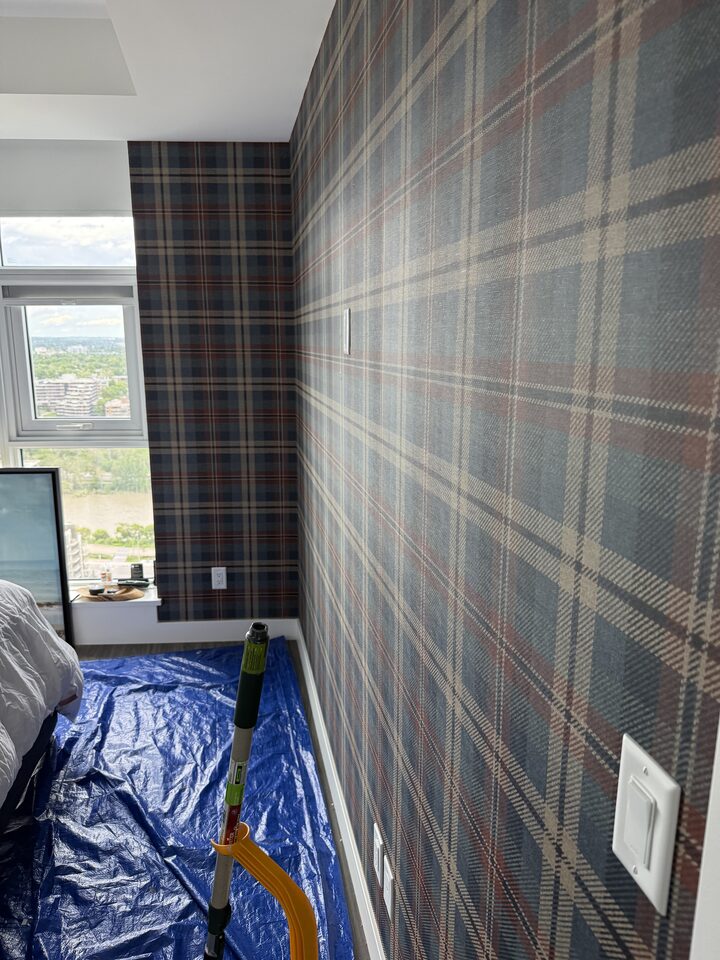 Tartan plaid wallcovering pattern alignment across a full feature wall in a downtown Calgary high-rise condo