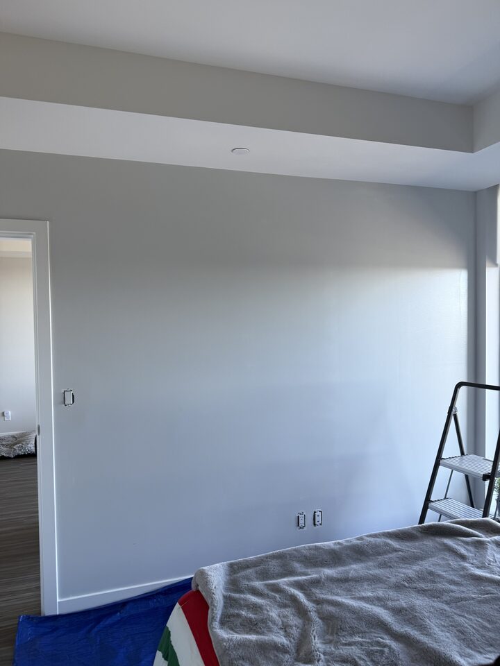 Prepped condo bedroom wall before Type II vinyl wallcovering installation in East Village downtown Calgary