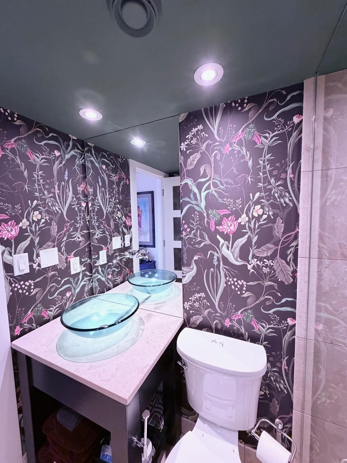 Night Garden dark botanical mural wallpaper and a deep green painted ceiling in an Eau Claire condo bathroom, Calgary