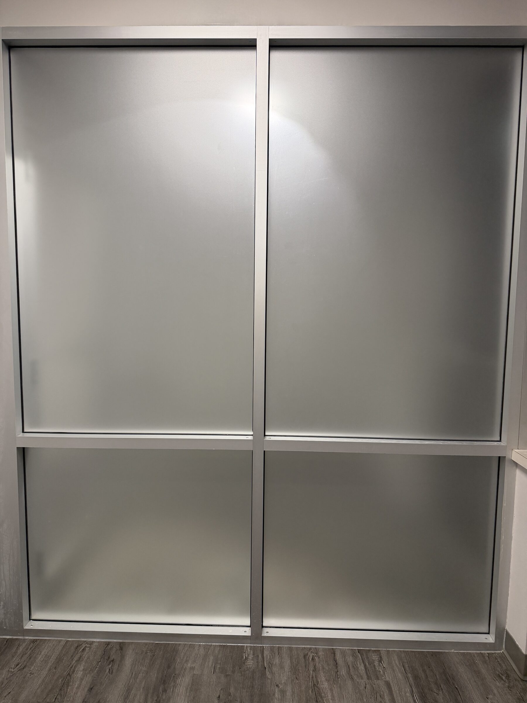 Office glass wall in Great Plains, SE Calgary, with all four panes frosted in dusted crystal privacy film