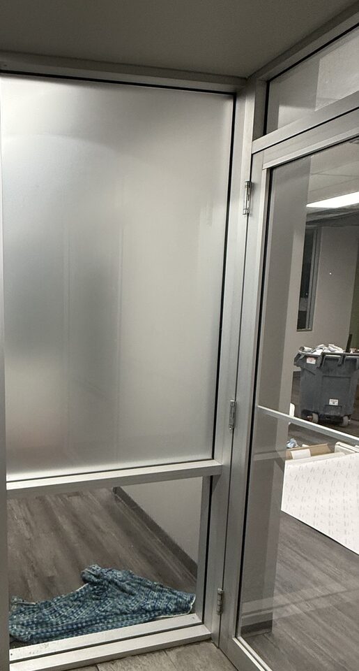 Dusted crystal privacy film install in progress on an office glass wall in Great Plains, SE Calgary: upper pane frosted, lower pane still clear