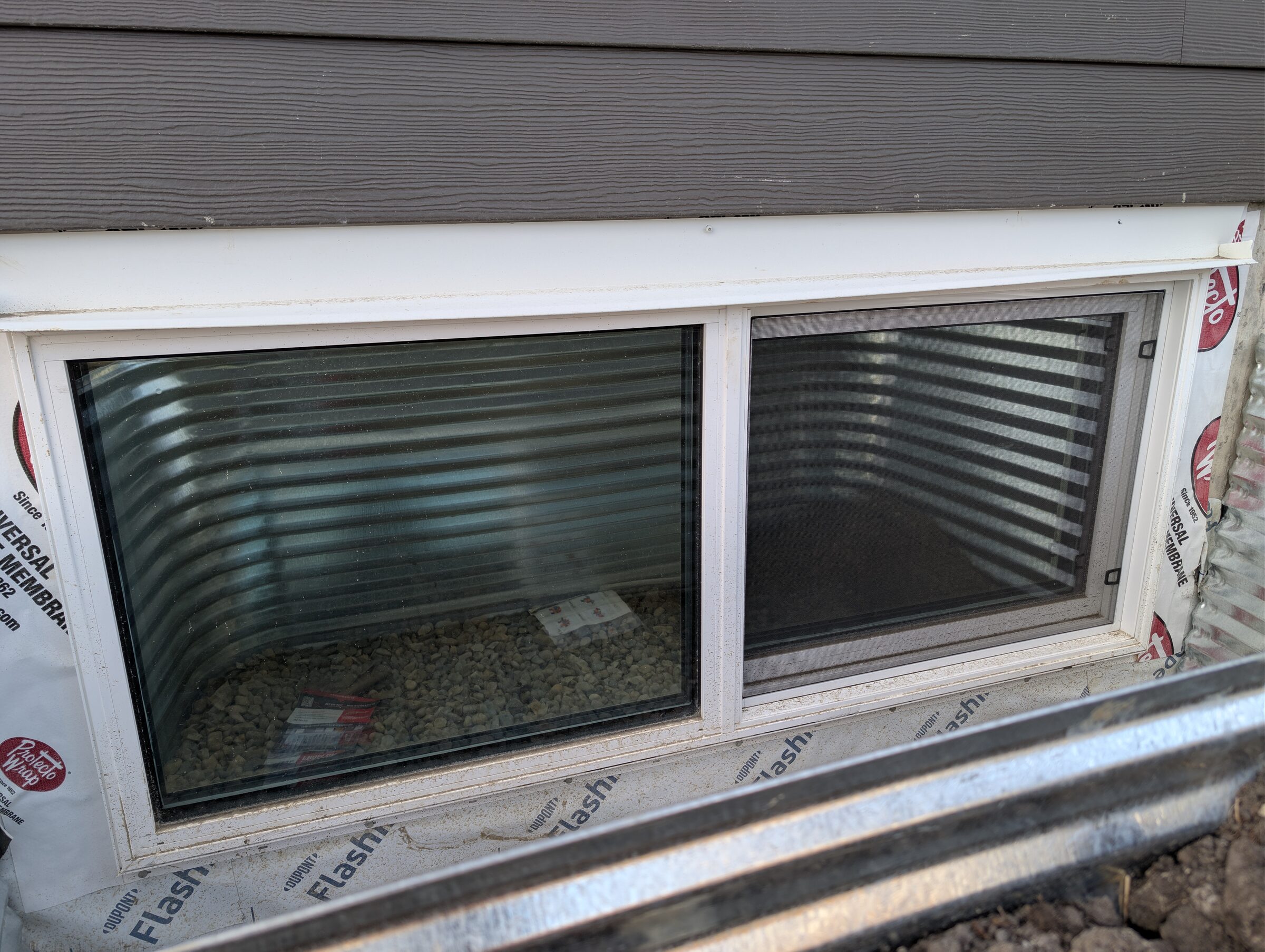 Solar and security window film installed on a basement window in Harmony Rocky View County