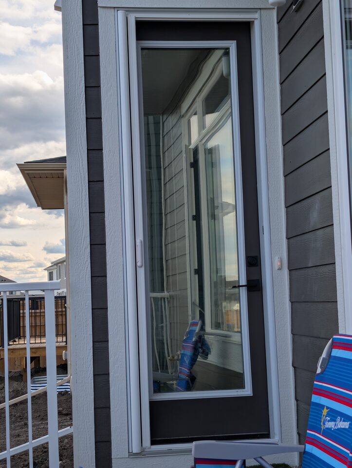 After exterior photo of solar and security window film on side door glass in Harmony Rocky View County