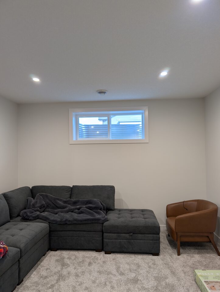 After room view of a lower-level living room window with solar window film in Harmony Rocky View County