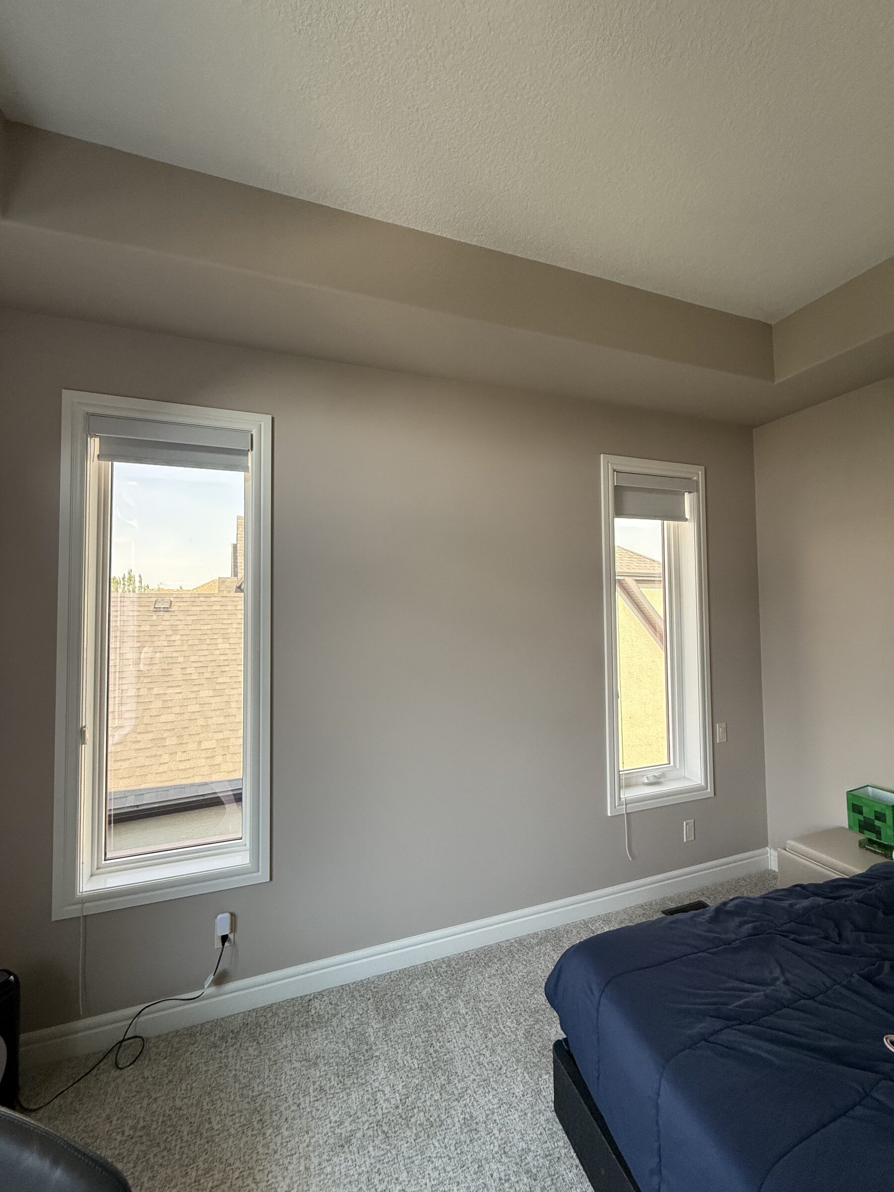 Kids bedroom with two transom windows finished with heat-control solar window film in Heritage Pointe, south of Calgary