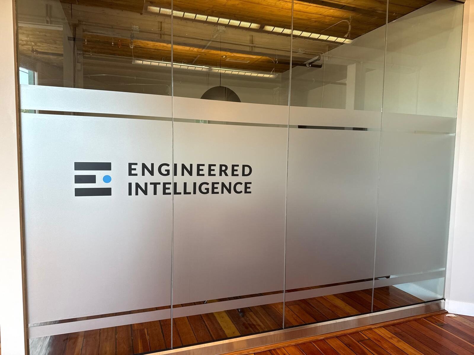 Finished branded frosted privacy film on office meeting room glass in Inglewood Calgary