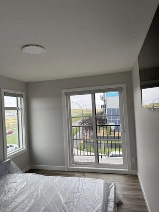 Residential solar window film installation in Livingston, NW Calgary. See kitchen and bedroom balcony-glazing photos, plus room-by-room plan