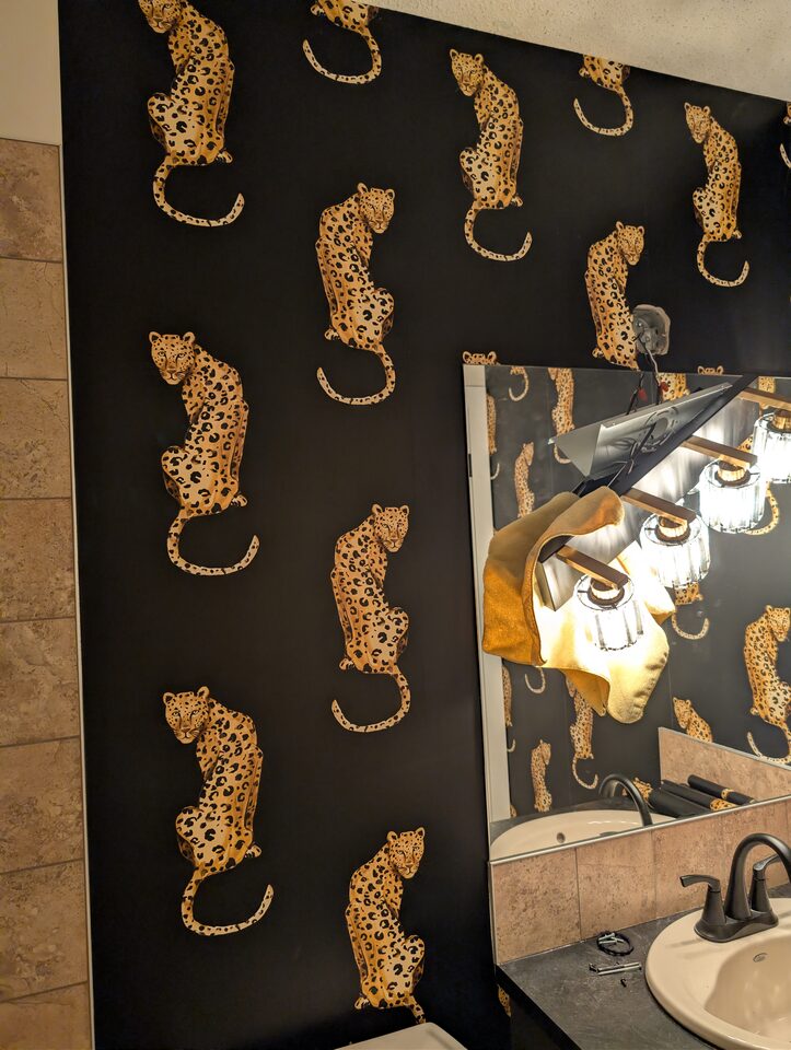 Mirror detail after peel-and-stick leopard wallpaper installation in McKenzie Towne Calgary