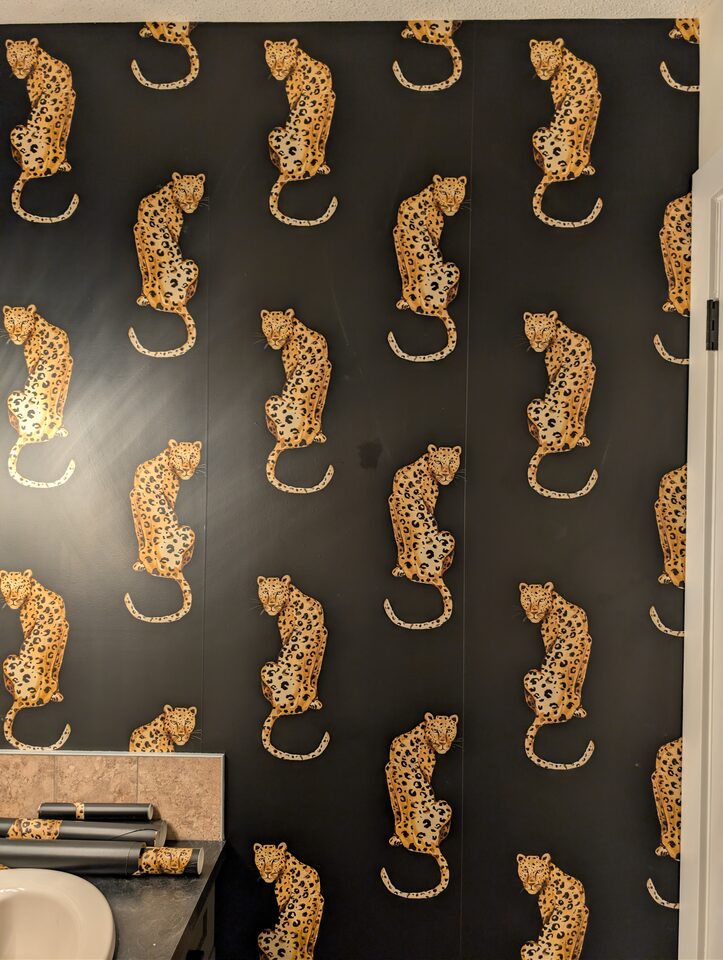 Leopard pattern detail after peel-and-stick wallpaper installation in a McKenzie Towne Calgary powder room