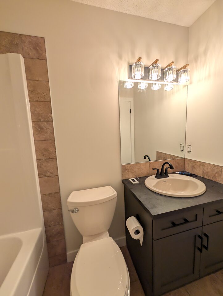 Before overview of a McKenzie Towne Calgary powder room before peel-and-stick wallpaper installation