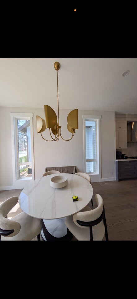 Interior dining room view through solar window film on two tall narrow windows in a Mount Pleasant NW Calgary home