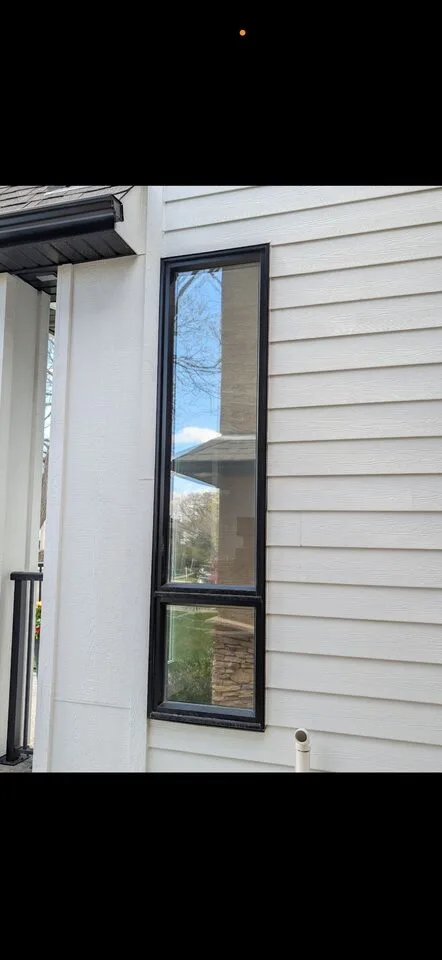 Mount Pleasant Calgary new-build with solar window film on tall narrow black-frame windows