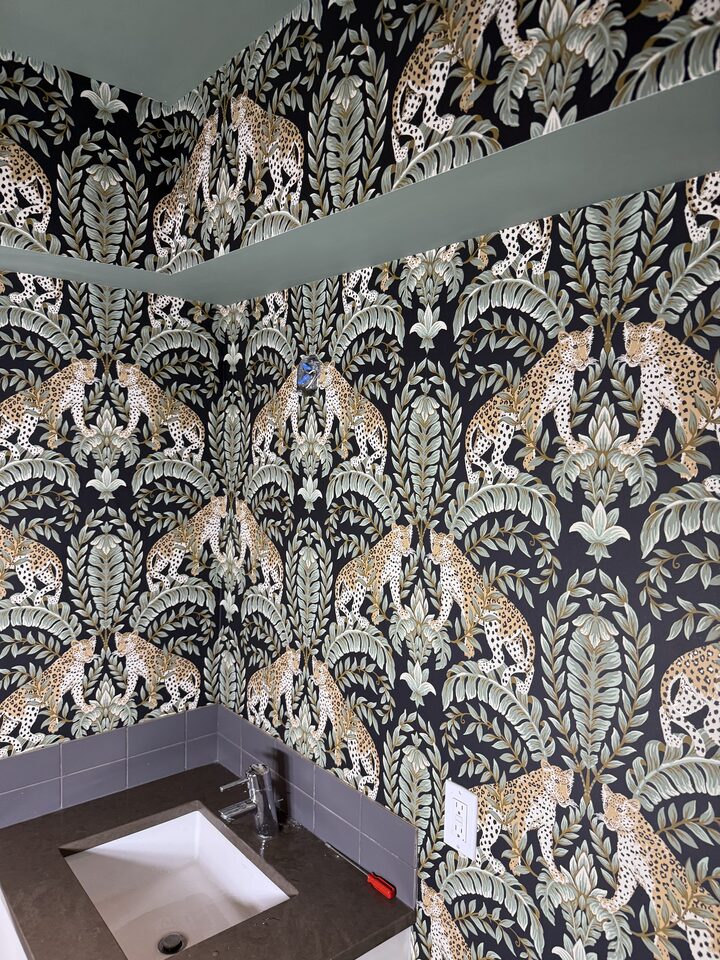 Leopard botanical wallpaper on dark ground around the vanity wall of a Parkland, SE Calgary bathroom