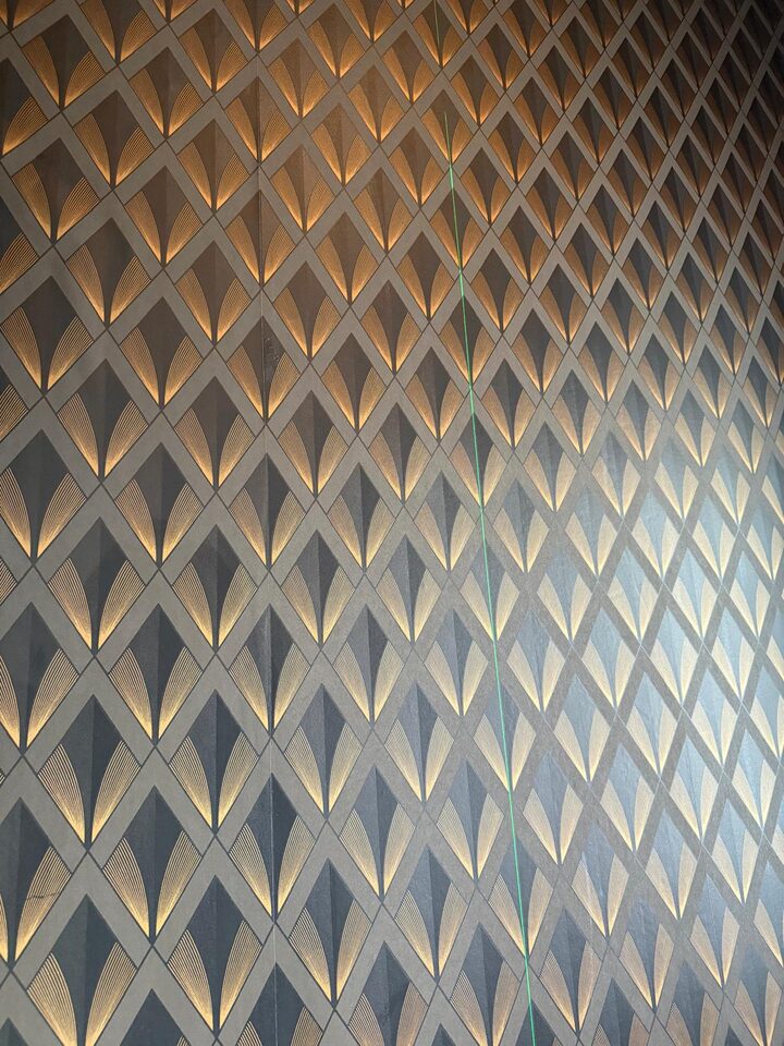 Art deco diamond fan wallpaper wrapped around a powder room corner in Patterson, SW Calgary