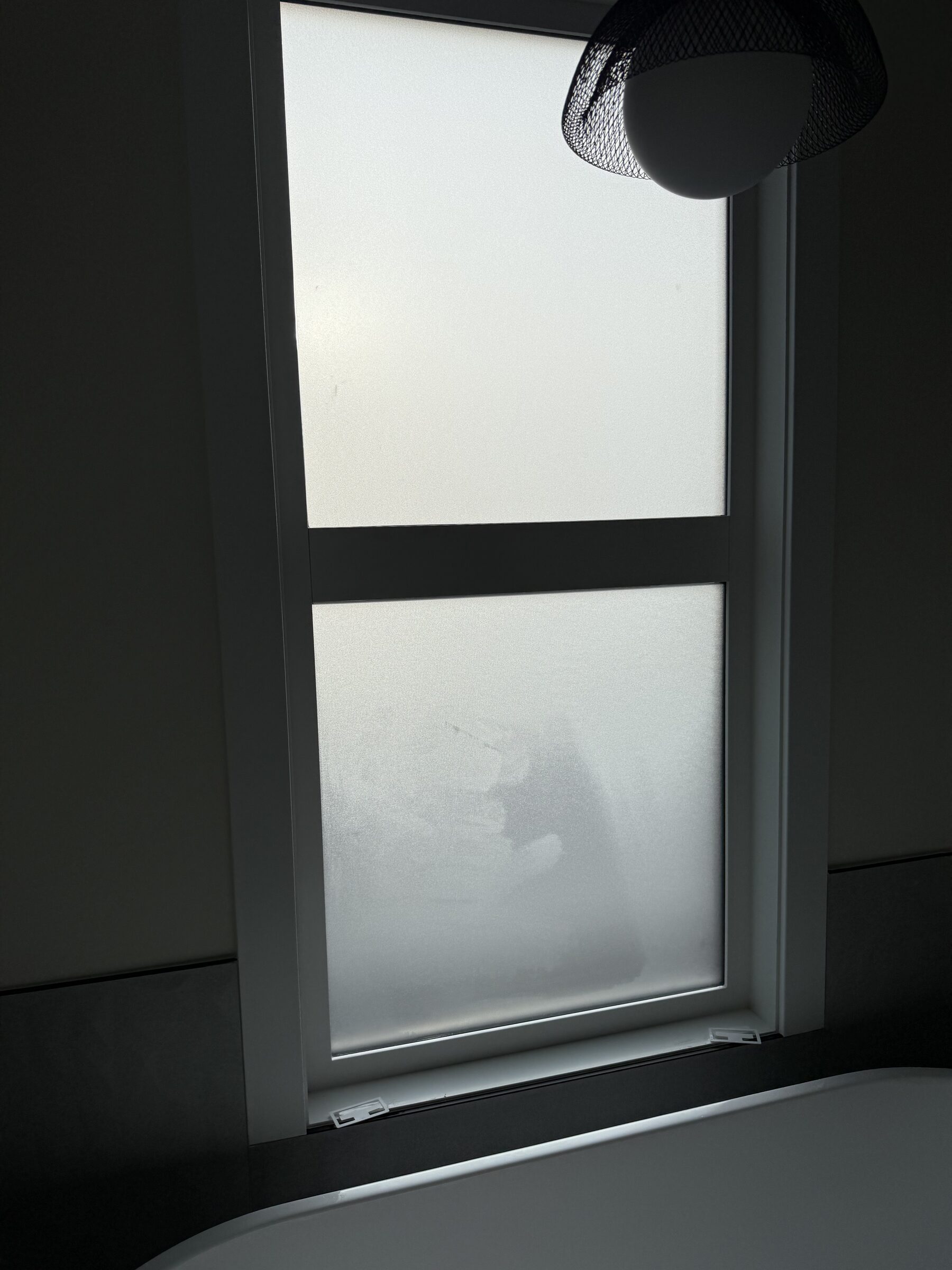 Privacy window film being installed on residential windows in a Calgary home