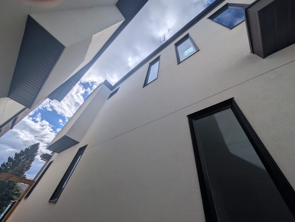 Before photo of high exterior windows before scaffold-access solar window film installation in Rosscarrock SW Calgary