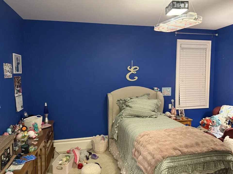 Royal-blue painted bed wall in a kids bedroom before the sheep-print wallpaper accent wall was installed, Springbank, Rocky View County