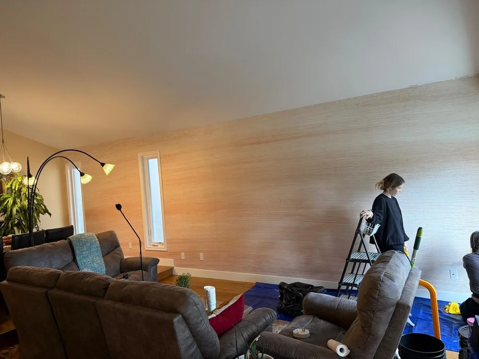 Light Happywall mural wallpaper installed on a long living room feature wall in Sundance SE Calgary