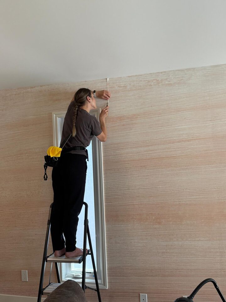 Detail photo of Happywall mural wallpaper installation around a narrow living room window in Sundance SE Calgary