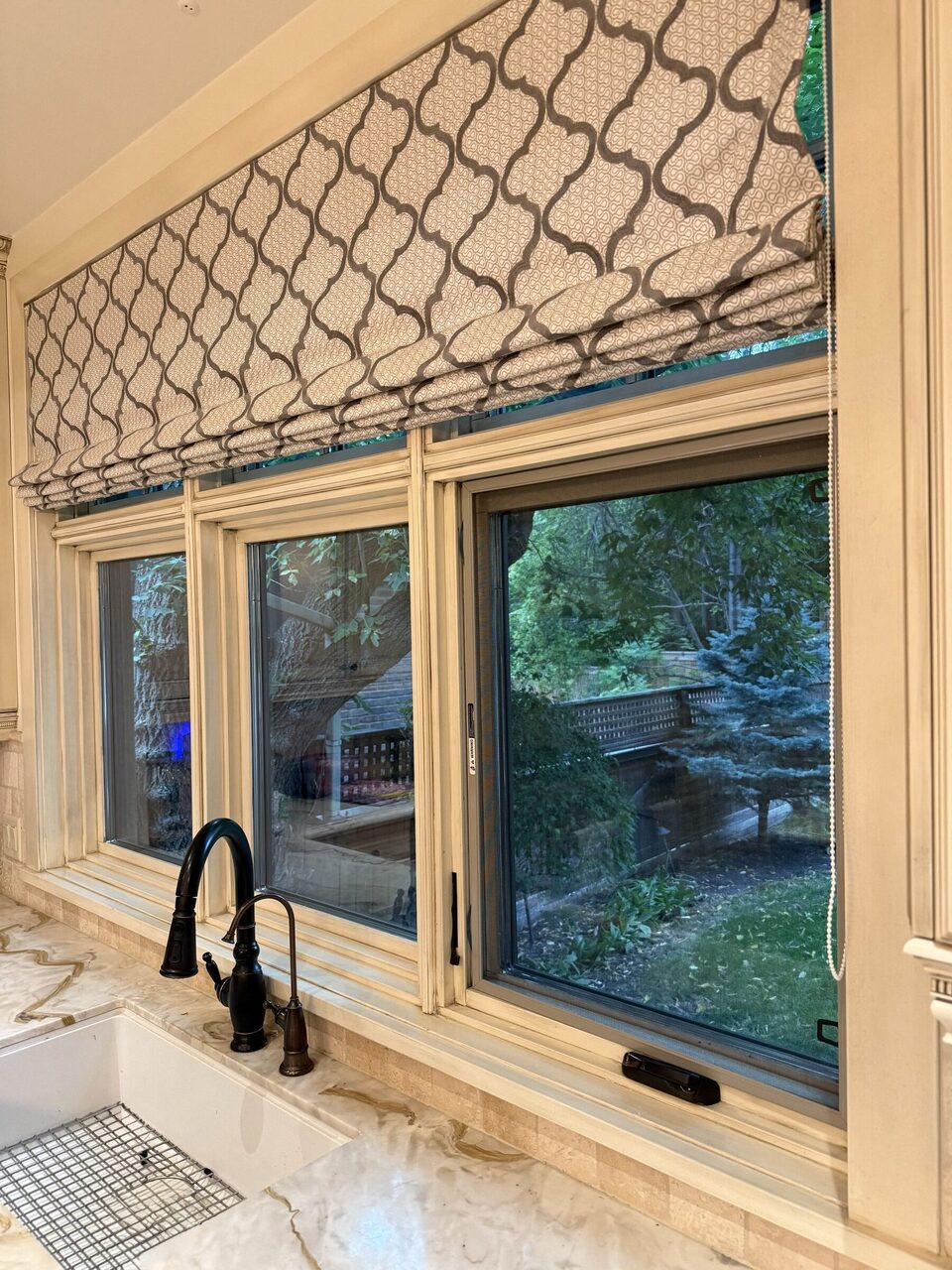 Kitchen windows above the sink, with existing trim and Roman blinds, photographed on site in Upper Mount Royal.