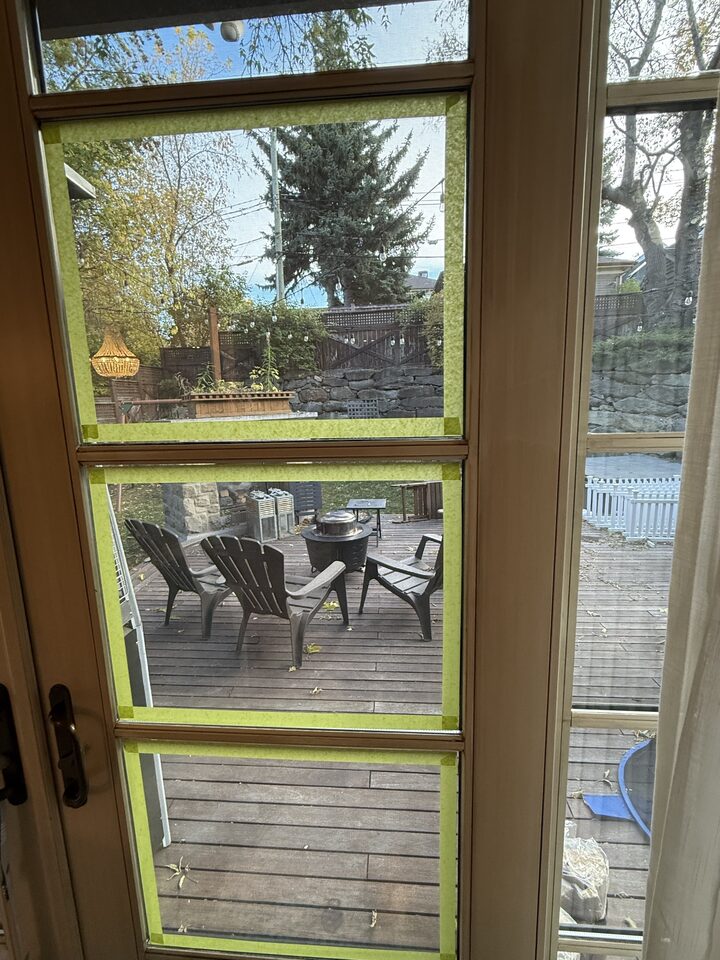 Divided-lite French door panes with 8 mil security film during the frame-anchoring stage, Upper Mount Royal, SW Calgary