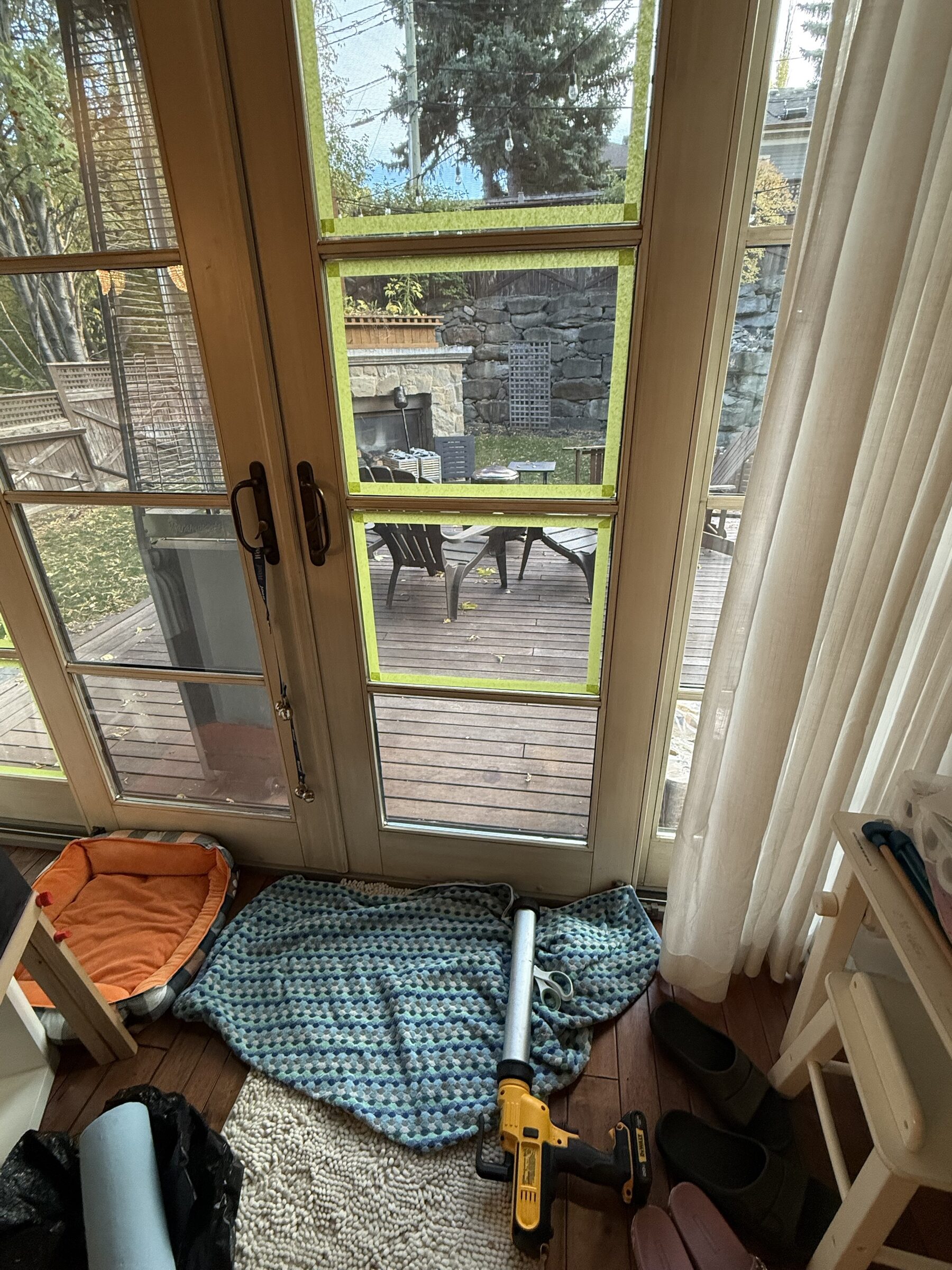 French door pair with XPEL 8 mil security window film on the glass during frame anchoring, Upper Mount Royal, SW Calgary