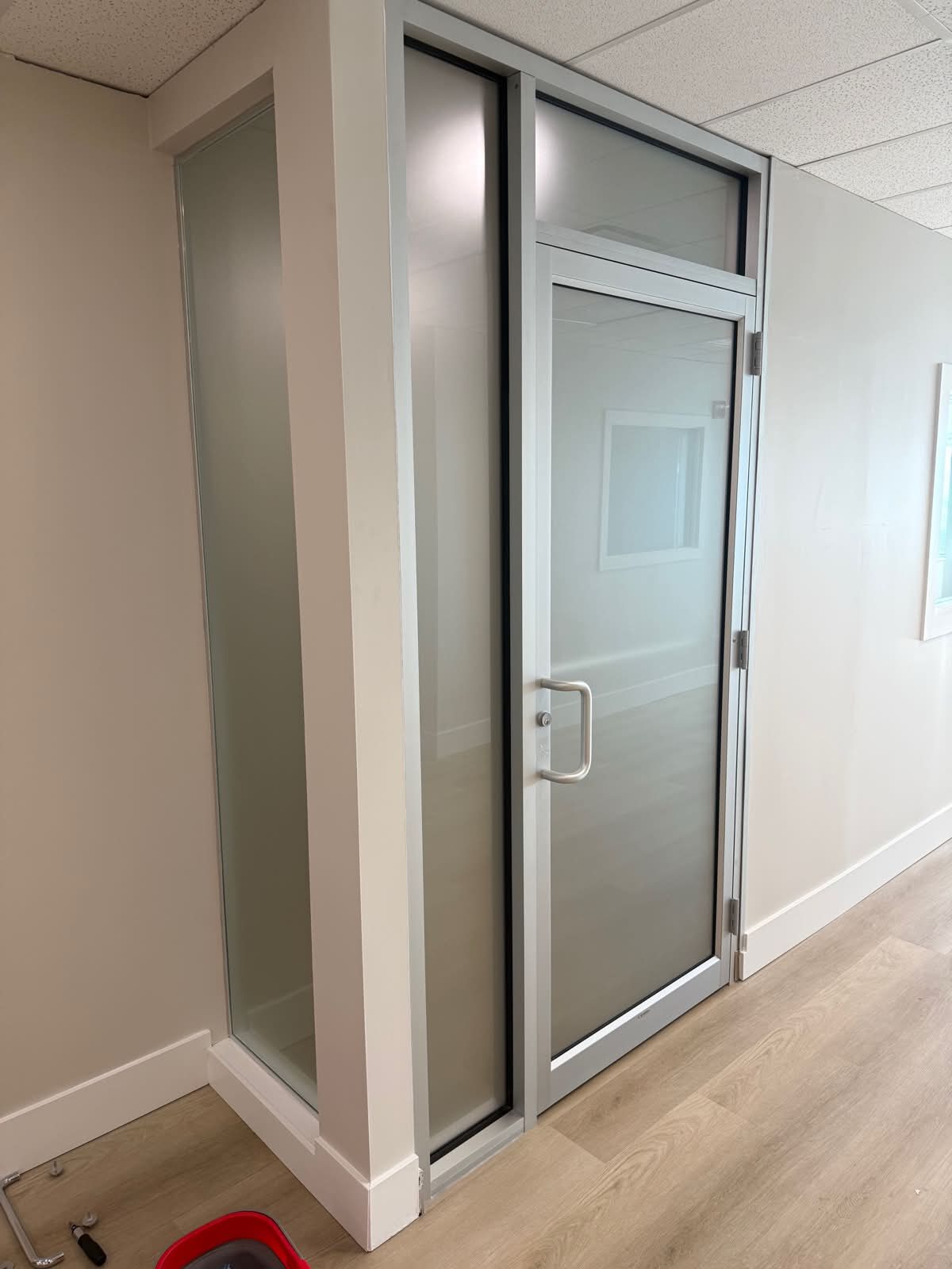 Dusted Crystal frosted privacy window film installed on an office glass door and sidelites in Vista Heights NE Calgary