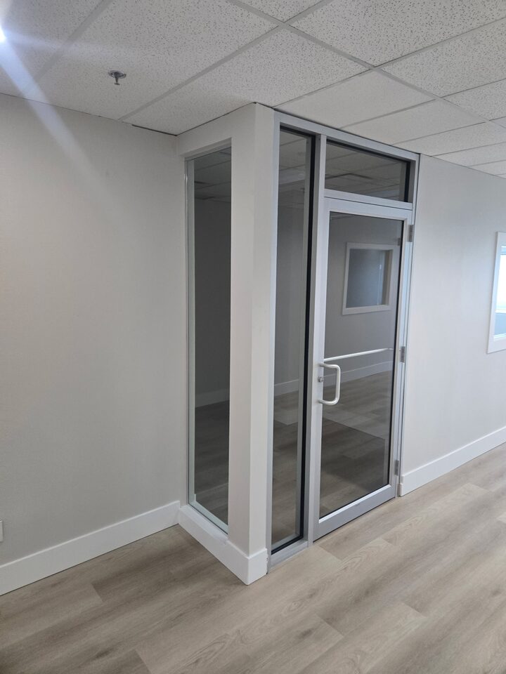 Before photo of clear office glass door and sidelites before frosted privacy window film installation in Vista Heights NE Calgary