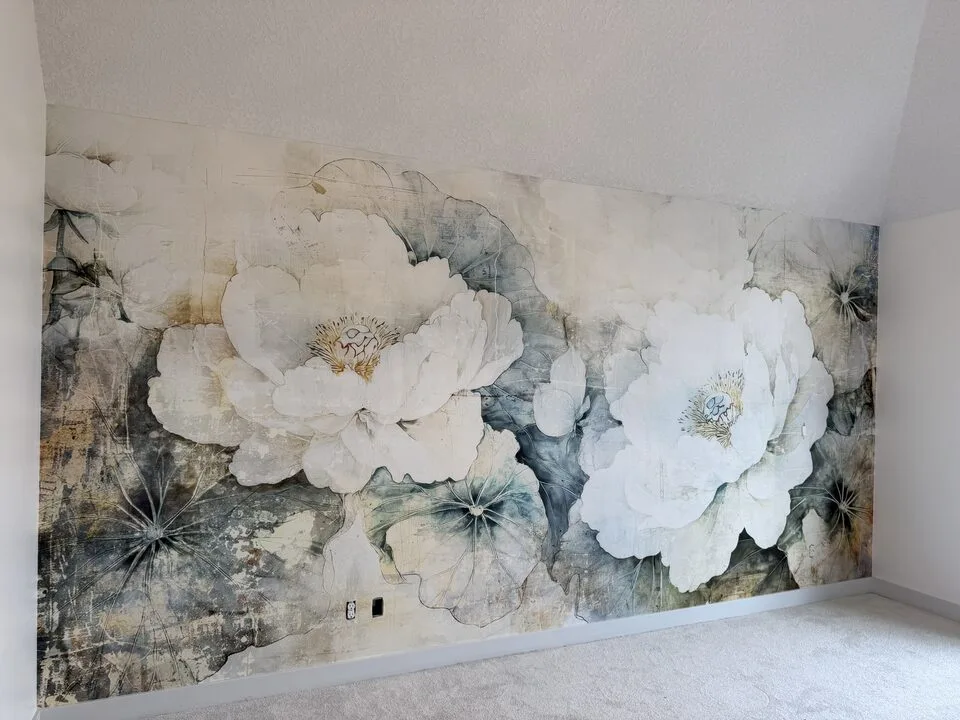 Oversized white peony mural wallpaper across a bedroom feature wall with a sloped ceiling in Winston Heights, NE Calgary