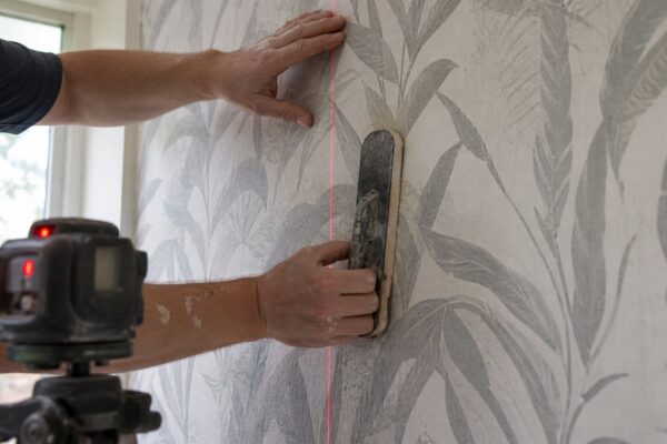 Wallpaper installation planning on detailed wall finish work